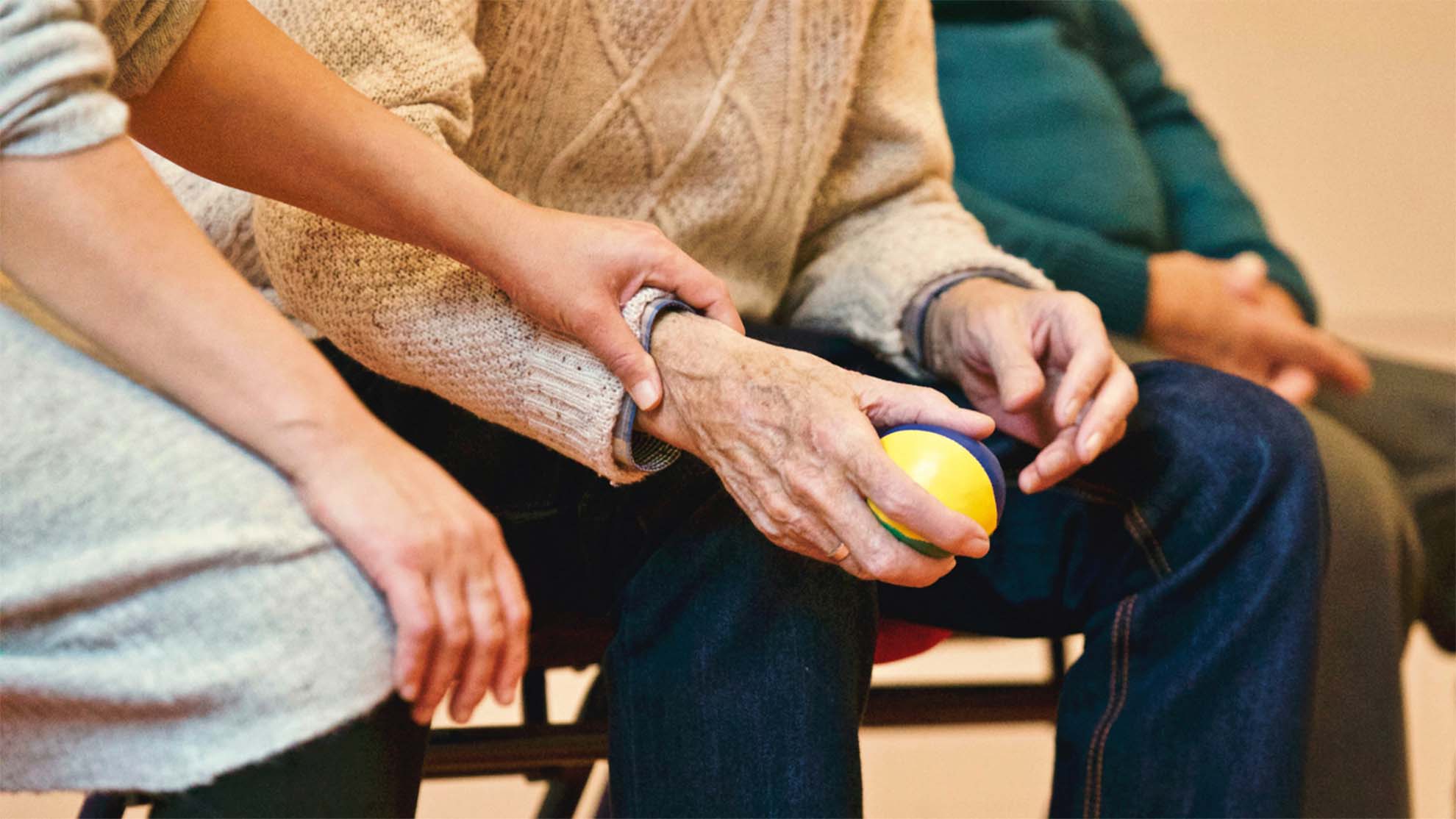 Resident playing ball with carer