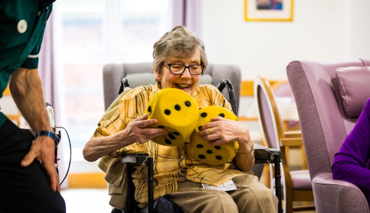 resident playing with big dice