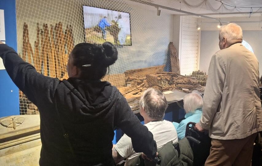 carers wheeling residents around a sea museum 