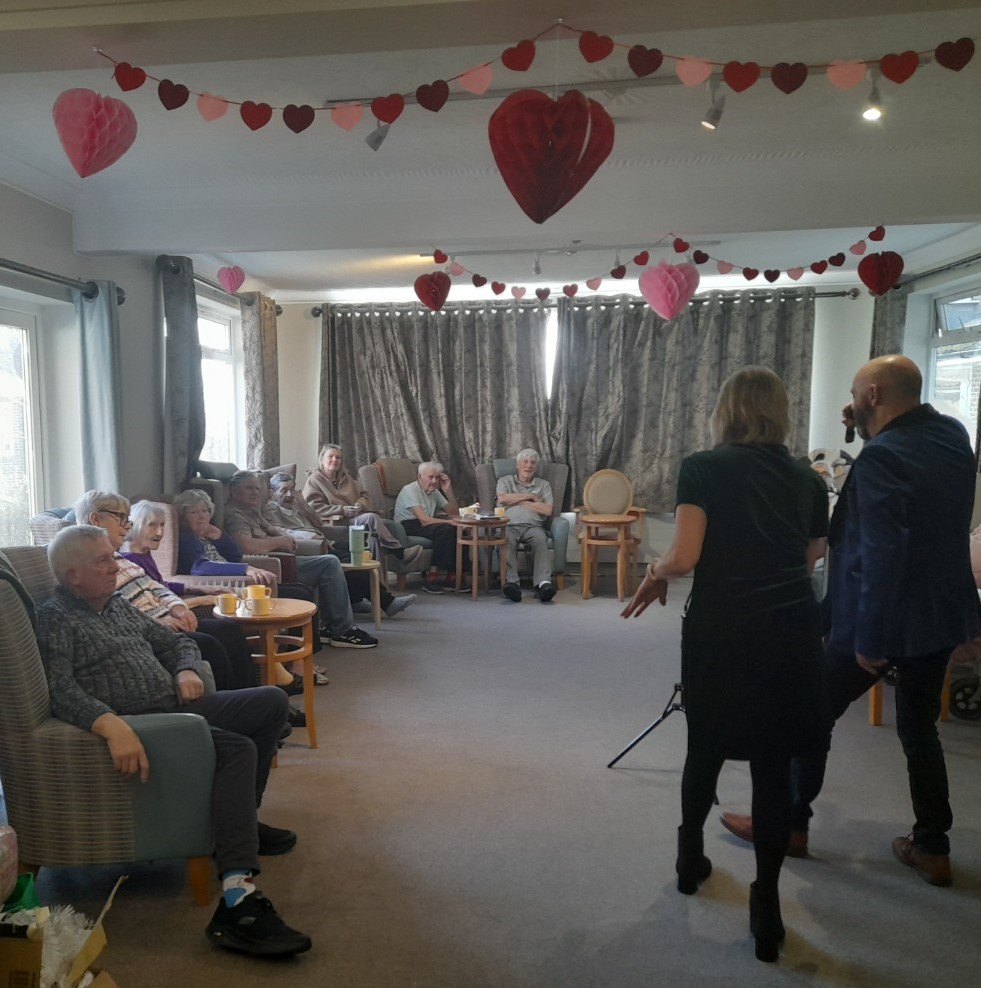 residents in the lounge listening to the singers