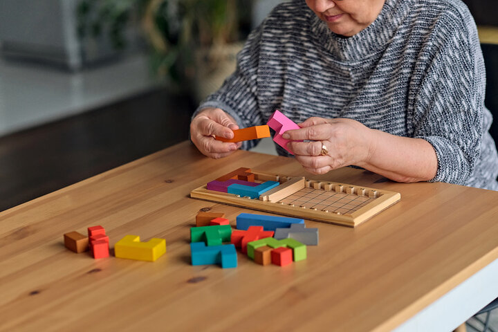 older woman doing a puzzle