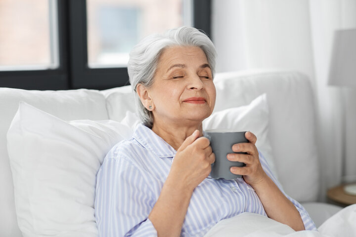 old woman in bed smiling
