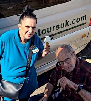 nurse-wearing-a-uniform-with-a-resident-eating-ice-cream