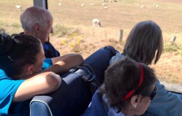 residents-looking-out-of-a-bus-window